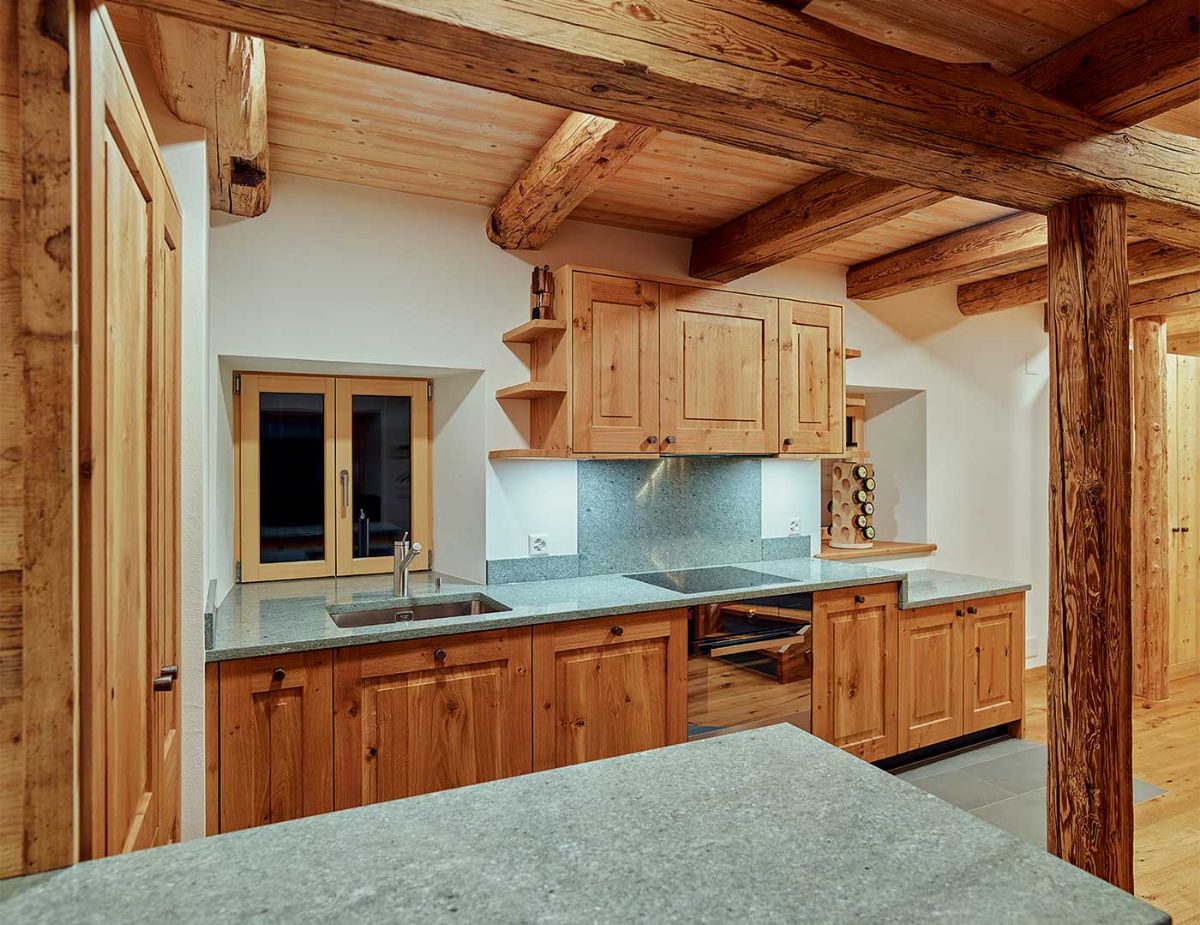Cuisine moderne dans une ambiance bois et pierres.